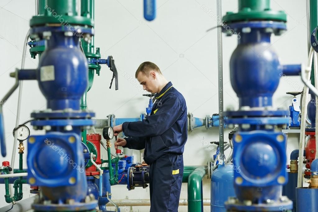 Technician performing preventative maintenance on commercial mechanical equipment to support system performance, efficiency, and reliability.
