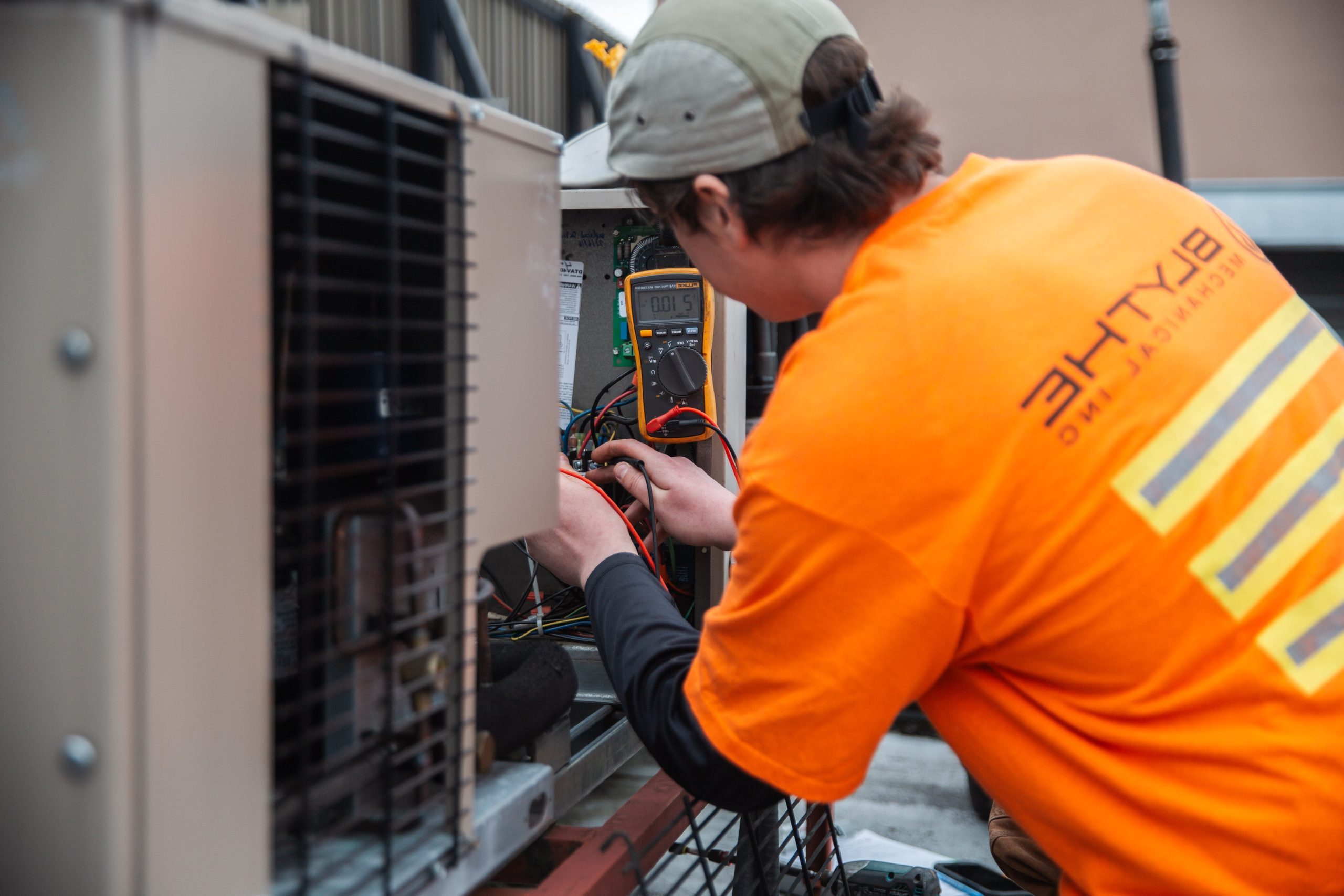 Technician repairing an industrial refrigeration system, inspecting cooling equipment and mechanical components during commercial HVAC service.