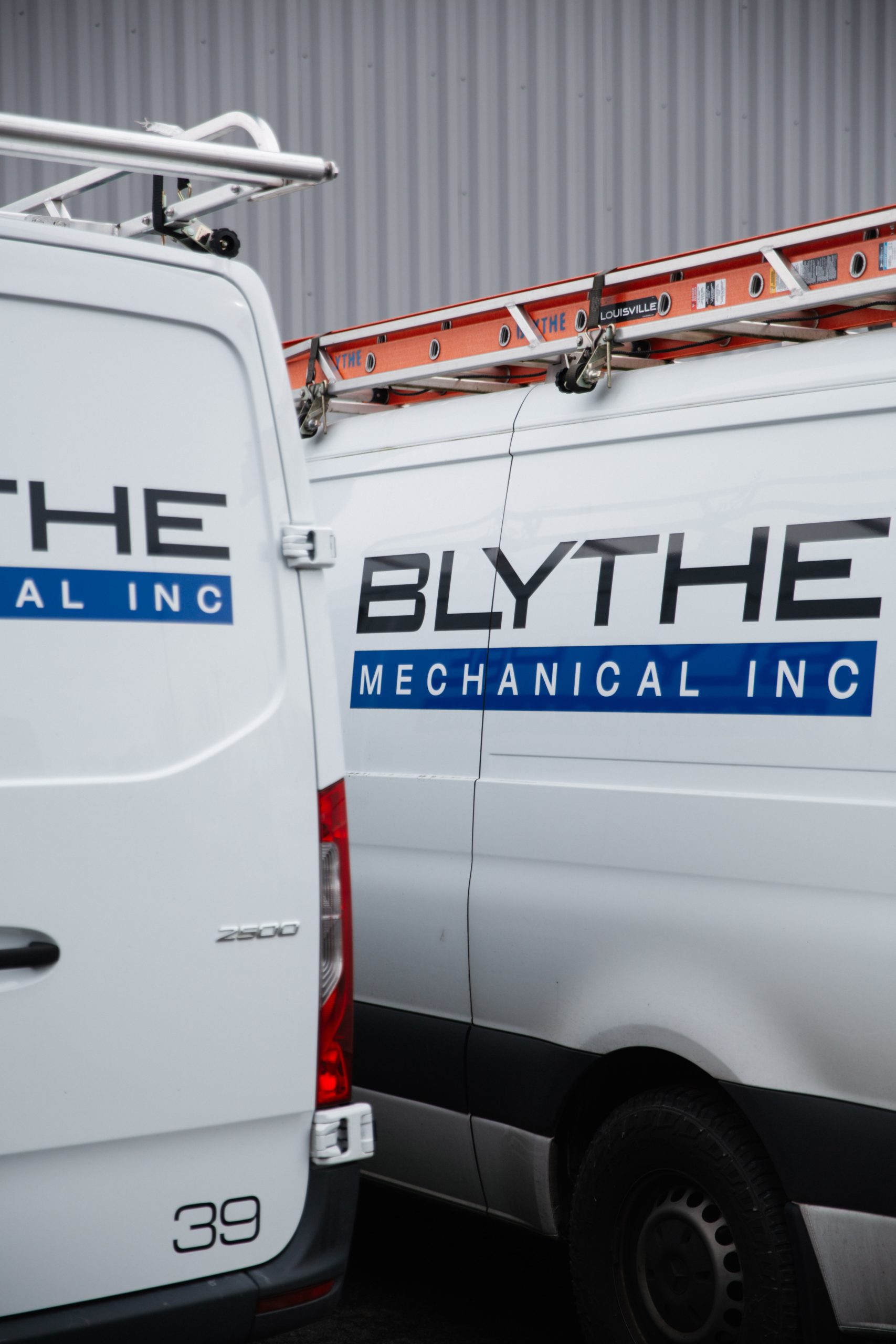 Blythe Mechanical service vans parked outside a commercial facility, representing responsive HVAC, plumbing, and refrigeration service across Northwest Washington.