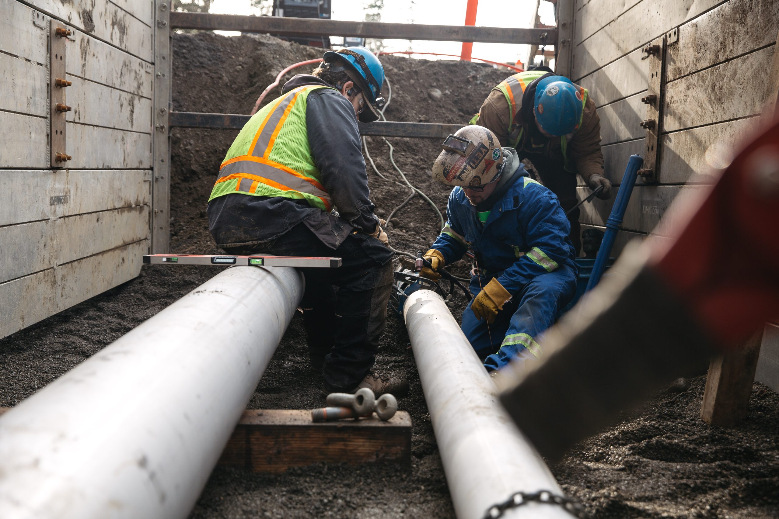 Blythe Mechanical technicians performing hands-on mechanical work at a commercial job site, representing career opportunities in the skilled trades.